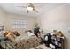 Bedroom with a ceiling fan, one window, a bed, a bookcase, and a chest of drawers at 6795 23Rd S St, St Petersburg, FL 33712