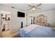 Relaxing bedroom with a mounted TV, an en-suite bathroom, and ample storage, promoting relaxation and comfort at 6795 23Rd S St, St Petersburg, FL 33712