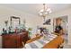 Formal dining room featuring a chandelier, dining table, and dark wood sideboard at 6795 23Rd S St, St Petersburg, FL 33712