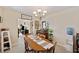 Inviting dining room featuring a classic chandelier and ample natural light, perfect for Gathering meals and entertaining at 6795 23Rd S St, St Petersburg, FL 33712