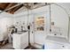 Laundry room featuring a washer, dryer, pegboard, and door leading into the kitchen at 6795 23Rd S St, St Petersburg, FL 33712