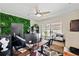 Office featuring a green wall, modern desk setup with monitors, and a ceiling fan at 6795 23Rd S St, St Petersburg, FL 33712