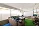 Enclosed patio area with a ceiling, outdoor seating arrangement, projector screen, and astroturf at 6795 23Rd S St, St Petersburg, FL 33712
