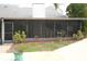 Relaxing screened-in patio overlooking the backyard featuring fresh landscaping at 6806 Beach Blvd, Hudson, FL 34667