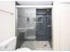 Modern bathroom featuring a sleek glass enclosed shower with black and gray tile at 6806 Beach Blvd, Hudson, FL 34667