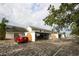 Spacious exterior showcasing multiple carports for convenient parking and beautifully landscaped surroundings at 6806 Beach Blvd, Hudson, FL 34667