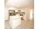 Updated kitchen boasts an island, stainless steel appliances, and white cabinetry at 6806 Beach Blvd, Hudson, FL 34667