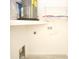 Well-lit laundry room features modern water heater, washer hookups and wire shelving storage at 6806 Beach Blvd, Hudson, FL 34667
