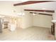 Spacious living area with vaulted ceilings, wood beams, brick fireplace, and open layout at 6806 Beach Blvd, Hudson, FL 34667