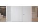Bedroom featuring light hardwood floors, an open closet, and updated bathroom at 6806 Beach Blvd, Hudson, FL 34667
