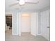 Bedroom featuring light hardwood floors, an open closet, and updated bathroom at 6806 Beach Blvd, Hudson, FL 34667