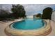 Large community pool with clear water, adjacent hot tub, and plenty of lounge chairs for relaxation at 6806 Beach Blvd, Hudson, FL 34667