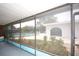 Screened-in view of a large pool, lounge area, and the clubhouse at 6806 Beach Blvd, Hudson, FL 34667