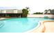 Large community pool with clear blue water, surrounding deck area, and lush landscaping at 6806 Beach Blvd, Hudson, FL 34667