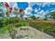 Beautifully landscaped backyard with manicured hedges, flowers, and a bench offering a serene outdoor escape at 7275 Crystal Spring Run, Weeki Wachee, FL 34607
