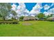 Spacious green backyard with elegant landscaping, offering a serene and private outdoor space at 7275 Crystal Spring Run, Weeki Wachee, FL 34607