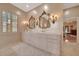 Elegant bathroom with dual vanities, decorative mirrors, and marble countertops at 7275 Crystal Spring Run, Weeki Wachee, FL 34607