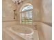 Close-up of soaking tub featuring a large window with shutters at 7275 Crystal Spring Run, Weeki Wachee, FL 34607