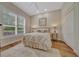 Bright bedroom with a large window, wood floors, and a comfortable bed with decorative side tables at 7275 Crystal Spring Run, Weeki Wachee, FL 34607