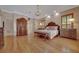Spacious bedroom featuring hardwood floors, large wardrobe, and natural lighting at 7275 Crystal Spring Run, Weeki Wachee, FL 34607