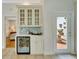 Butler's pantry area with wine cooler and cabinets at 7275 Crystal Spring Run, Weeki Wachee, FL 34607