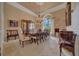 Formal dining room featuring a large table, chandelier, travertine floors and elegant decor at 7275 Crystal Spring Run, Weeki Wachee, FL 34607