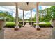 View from front porch highlighting the columns, brickwork, and landscaped circular drive at 7275 Crystal Spring Run, Weeki Wachee, FL 34607
