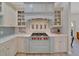 Kitchen featuring a high-end range with a decorative backsplash and custom cabinetry at 7275 Crystal Spring Run, Weeki Wachee, FL 34607