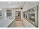 Bright kitchen with stainless steel appliances, double ovens, and a large refrigerator at 7275 Crystal Spring Run, Weeki Wachee, FL 34607