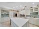 Open kitchen design with an island, stainless steel refrigerator, and modern fixtures at 7275 Crystal Spring Run, Weeki Wachee, FL 34607