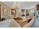 Bright living room featuring neutral tones, elegant sofas, and an ornate chandelier at 7275 Crystal Spring Run, Weeki Wachee, FL 34607
