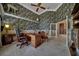 Home office featuring custom wallpaper, built-in shelves, and hardwood floors at 7275 Crystal Spring Run, Weeki Wachee, FL 34607