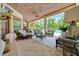 Inviting outdoor living area with comfortable seating, ceiling fans, and a view of the pool and lush greenery at 7275 Crystal Spring Run, Weeki Wachee, FL 34607