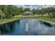 Scenic aerial shot of a tranquil pond with a fountain and a home in the background at 7275 Crystal Spring Run, Weeki Wachee, FL 34607