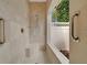 Modern shower with built-in bench, glass enclosure, and stainless steel fixtures at 7275 Crystal Spring Run, Weeki Wachee, FL 34607