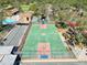 View of the community's outdoor basketball court, surrounded by trees and various amenities like bocce ball and a pool at 7518 Mediterranean Ct, Hudson, FL 34667