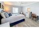 Comfortable bedroom with ceiling fan, floral bedding, and a white writing desk at 7518 Mediterranean Ct, Hudson, FL 34667