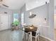 Cozy dining area features wainscoting and a window for natural light at 7518 Mediterranean Ct, Hudson, FL 34667
