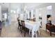 Open-concept dining area seamlessly flows into the living room, featuring stylish floors and modern decor at 7518 Mediterranean Ct, Hudson, FL 34667