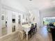 Elegant dining room features sleek wood floors, modern lighting, and mirrored wall at 7518 Mediterranean Ct, Hudson, FL 34667