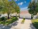 A front view showing the villas with a well-kept lawn, mature landscaping and attached garages at 7518 Mediterranean Ct, Hudson, FL 34667