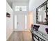 Bright foyer with wood floors, high ceilings, transom window, and stylish mirror at 7518 Mediterranean Ct, Hudson, FL 34667