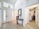 Inviting foyer with a front door, glass side panels, high ceilings and a view into the laundry room at 7518 Mediterranean Ct, Hudson, FL 34667
