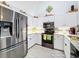 Kitchen features stainless steel appliances and white cabinets with granite counters at 7518 Mediterranean Ct, Hudson, FL 34667