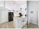 This bright kitchen features white cabinets, a breakfast bar, and black stainless steel appliances at 7518 Mediterranean Ct, Hudson, FL 34667