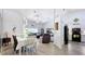 Bright living room featuring vaulted ceilings, stylish decor, and sleek wood floors at 7518 Mediterranean Ct, Hudson, FL 34667