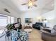 Comfortable living room offers vaulted ceilings, lots of natural light, and a cozy atmosphere at 7518 Mediterranean Ct, Hudson, FL 34667