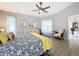 Comfortable bedroom with ceiling fan, neutral walls, and an en-suite bathroom at 7518 Mediterranean Ct, Hudson, FL 34667