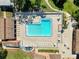 Aerial view of the community pool with plenty of lounge chairs and shaded picnic spots available at 7518 Mediterranean Ct, Hudson, FL 34667