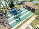 Overhead view of shuffleboard courts, with a covered picnic area and shade trees at 7518 Mediterranean Ct, Hudson, FL 34667